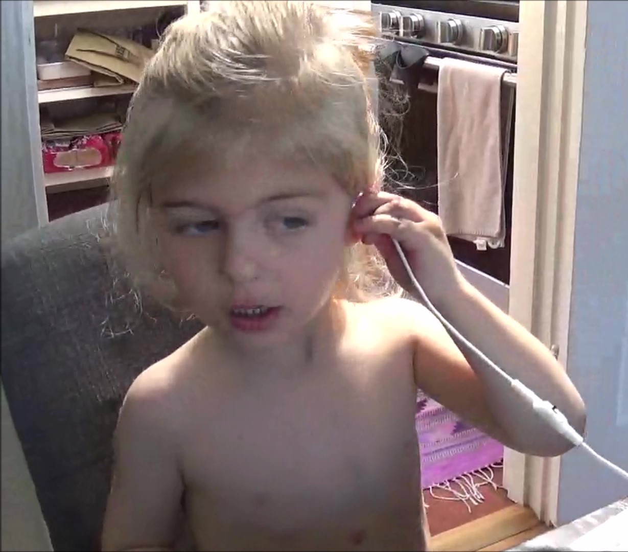 Child conducting self-exam with Zipline ear device
